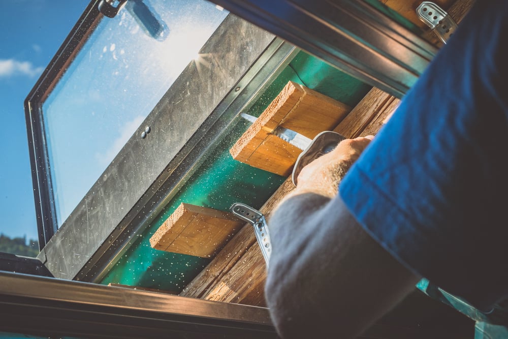 A,Person,Is,Cutting,A,Board,Of,Wood,Next,To